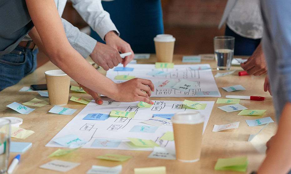 Meeting with documents on table and cups of coffee